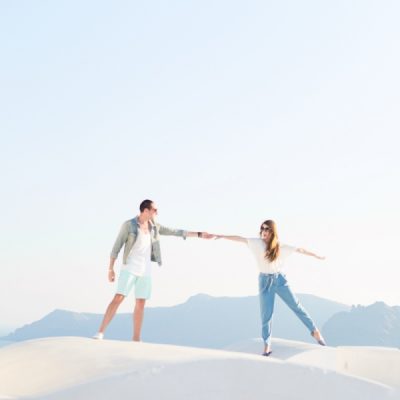 Two people standing on a white surface