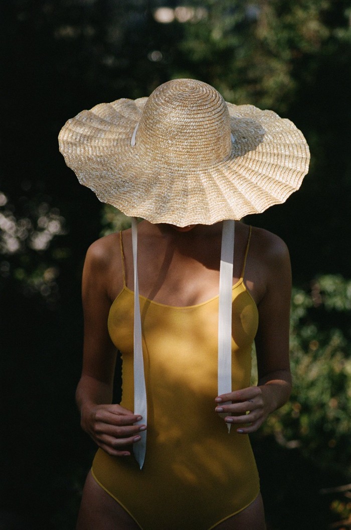 Scalloped Sun Hat on woman in a yellow dress