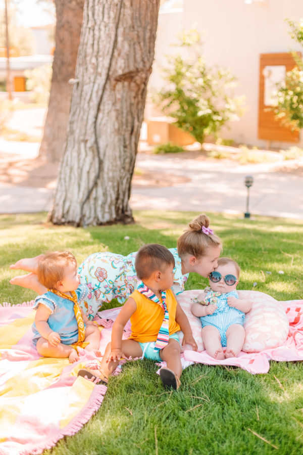 Kids sitting on blankets in a park