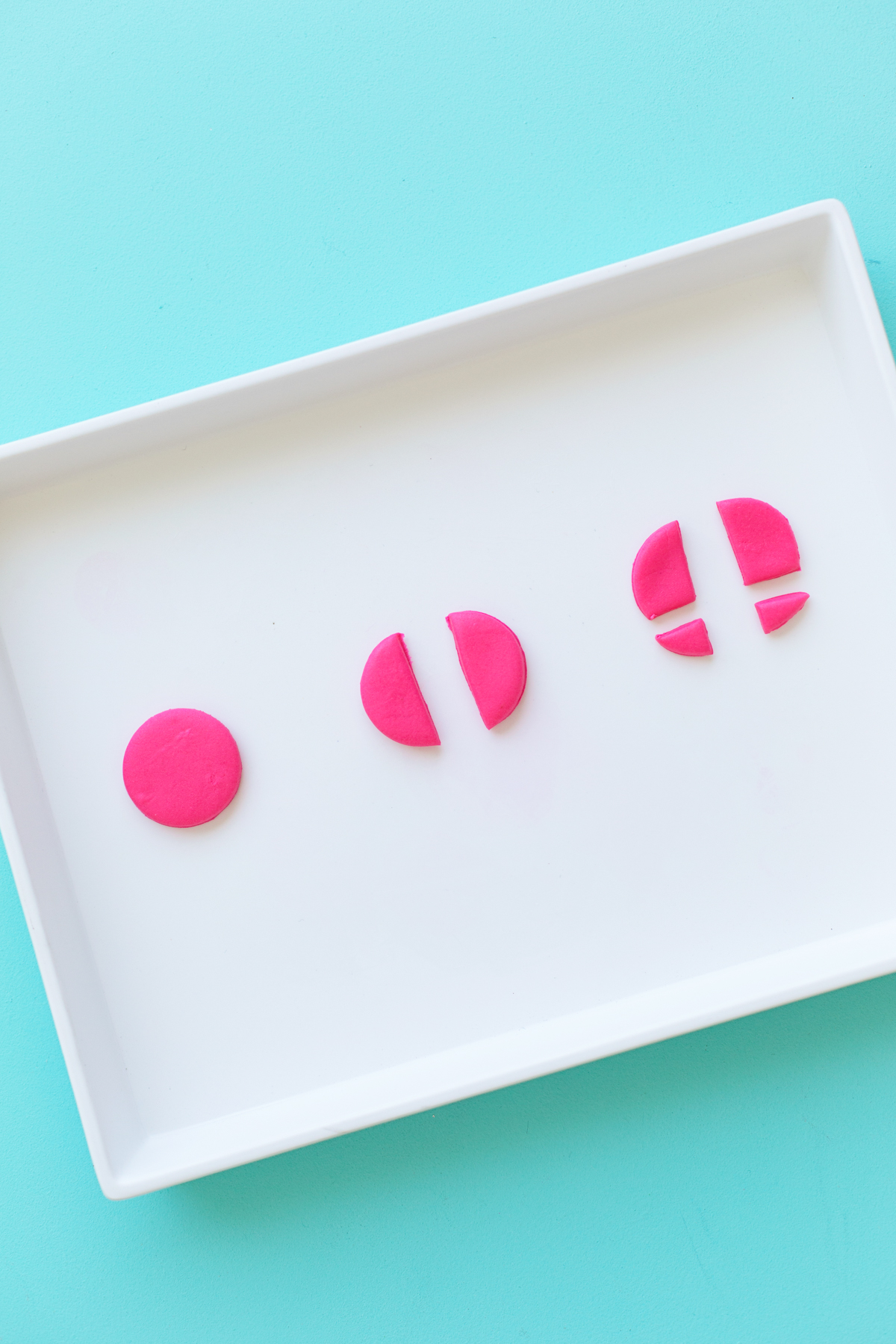 Pink fondant pieces on white plate