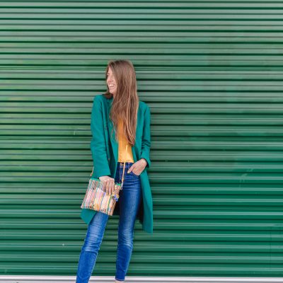 A woman standing in front of a green wall