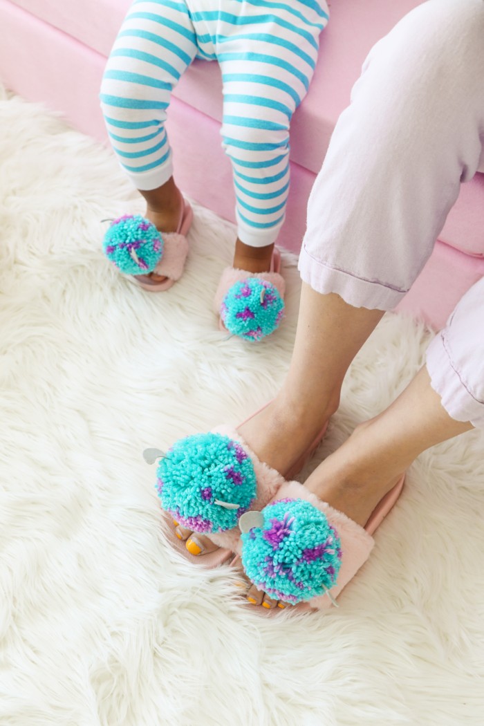 Mother and son wearing matching Monster's Inc Pom Pom slippers