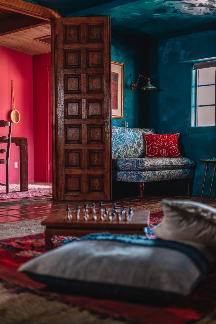 pillow and chess table in teal room