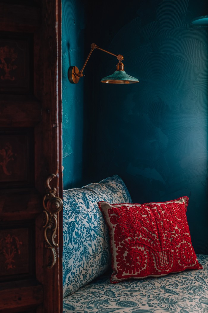 red pillow on floral chair