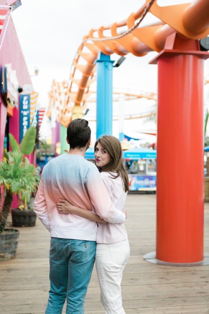 photo of couple with rollercoaster behind them