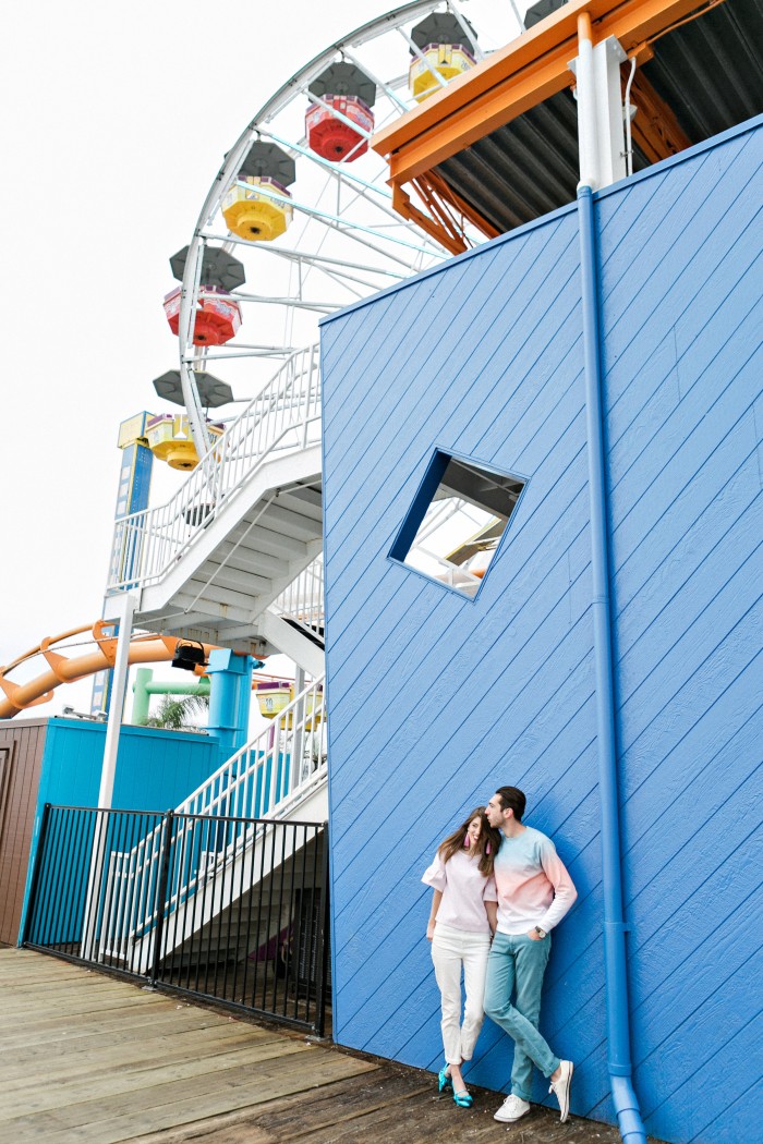 couple standing in front of blue wall