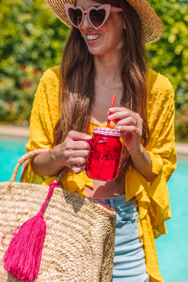 A woman holding a red glass