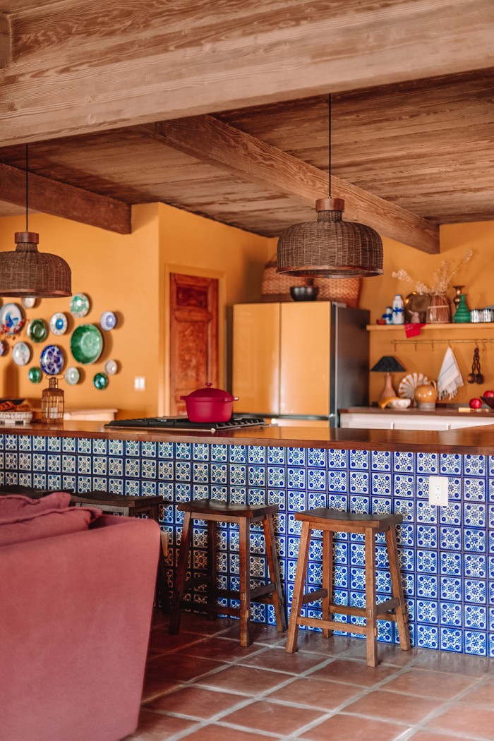 blue tile peninsula in yellow kitchen