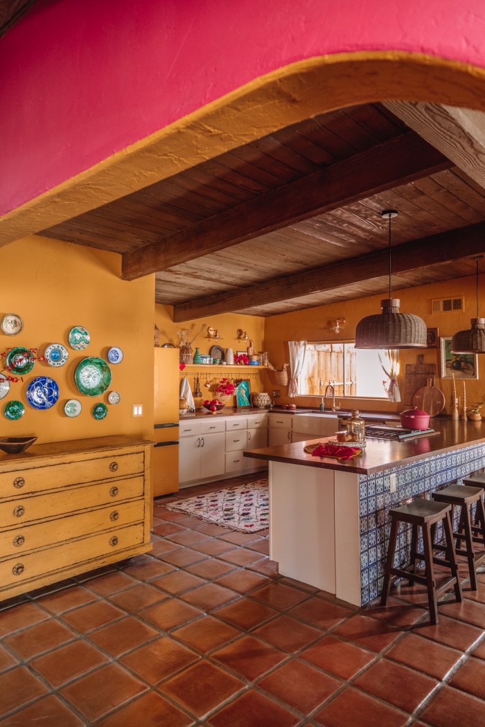 Yellow kitchen through pink arch